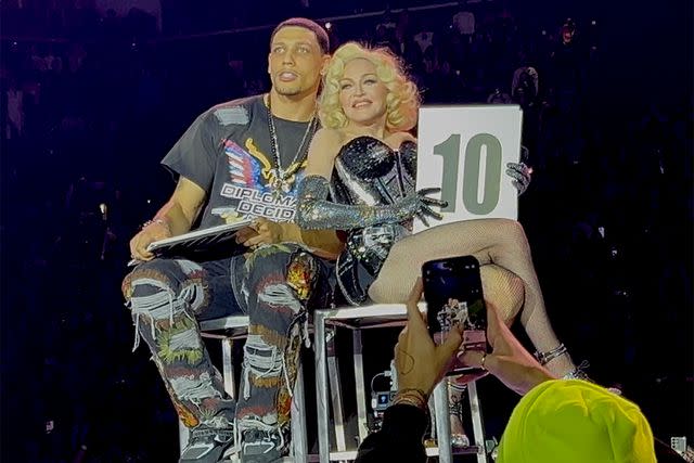 <p>Matthew Rettenmund / SplashNews</p> Josh Popper and Madonna appear on stage in Brooklyn on Dec. 13, 2023