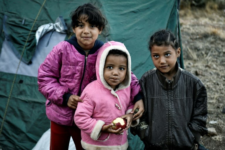 Young children who have recently arrived on the Greek island of Samos are living in tents in woods