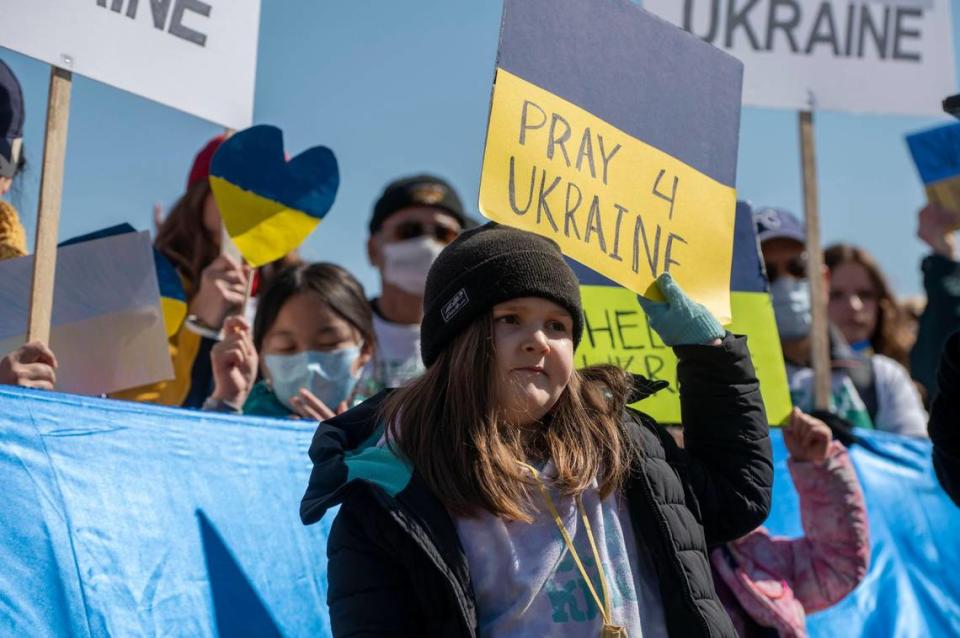 Calley Card accompanied her father, Cody Hall, at a demonstration to show solidarity with Ukraine at The Plaza on Saturday, Feb. 26, 2022. The event was organized in response to the recent military invasion by Russia.