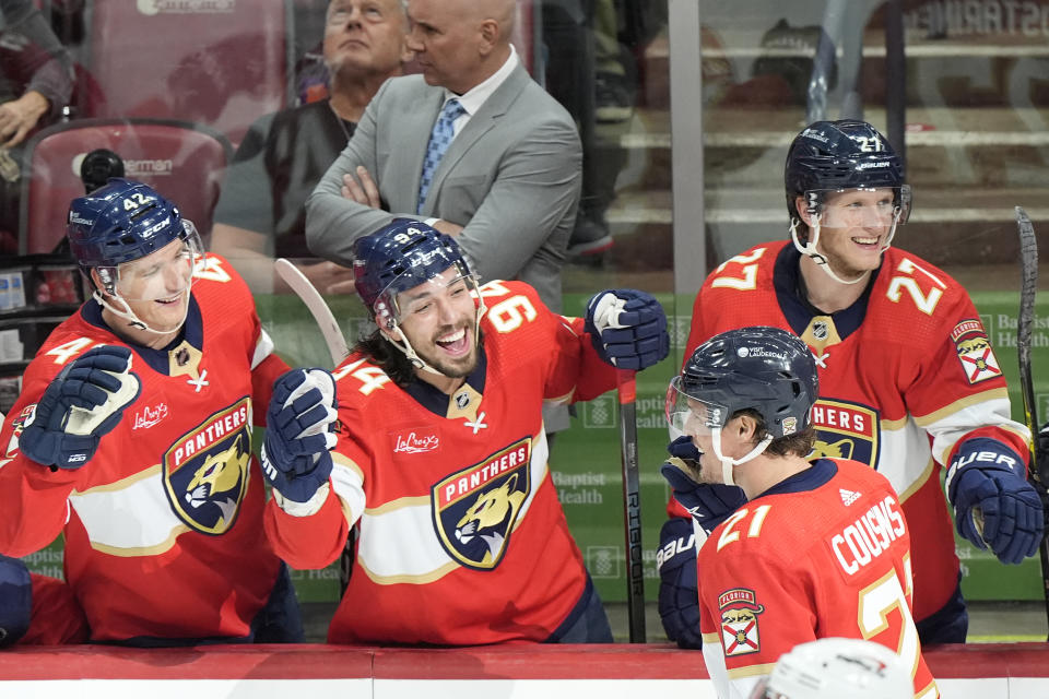 Florida Panthers center Nick Cousins (21) is congratulated by teammates after he scored during the second period of an NHL hockey game against the Washington Capitals, Saturday, Feb. 24, 2024, in Sunrise, Fla. (AP Photo/Wilfredo Lee)