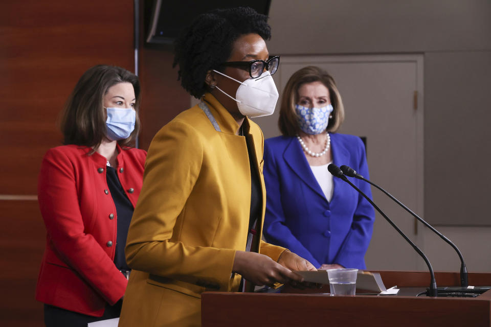 Rep. Lauren Underwood, D-Ill., center, speaks during a news conference with Speaker of the House Nancy Pelosi, D-Calif., right, and Rep. Angie Craig, D-Minn., left, on Capitol Hill in Washington, Friday, March 19, 2021. (Chip Somodevilla/Pool via AP)