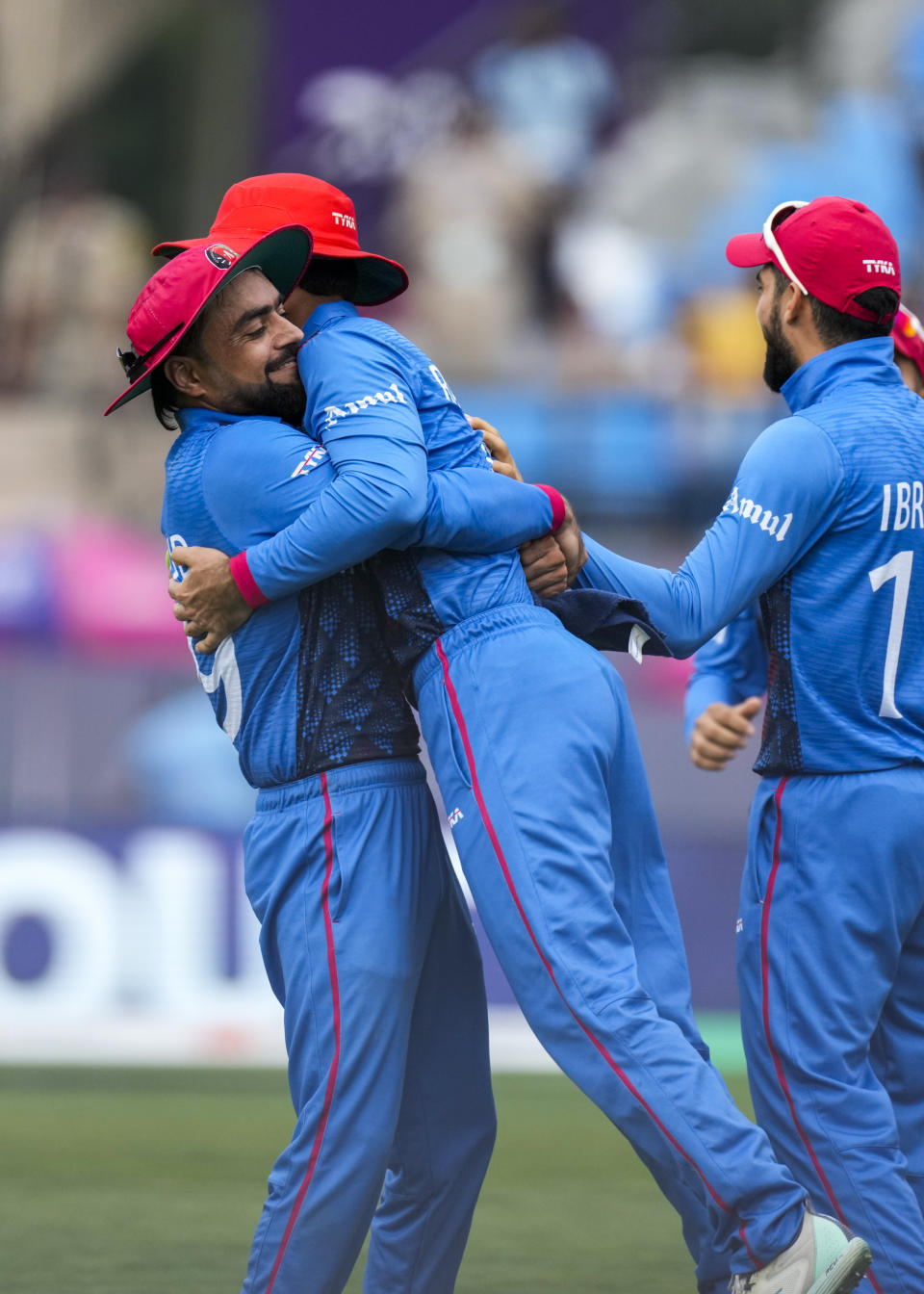 Afghanistan's Rahmat Shah is congratulated for the catch that dismissed Bangladesh's Mehidy Hasan Miraz during the ICC Cricket World Cup match between Afghanistan and Bangladesh in Dharamsala, India, Saturday, Oct.7, 2023. (AP Photo/Ashwini Bhatia)