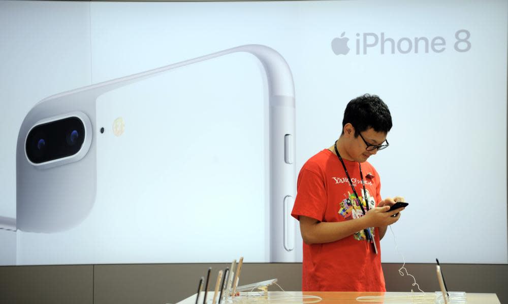 A single customer inspecting the new iPhone 8 in Tokyo, as demand for the now-on-sale phone is overshadowed by the soon to be released iPhone X.