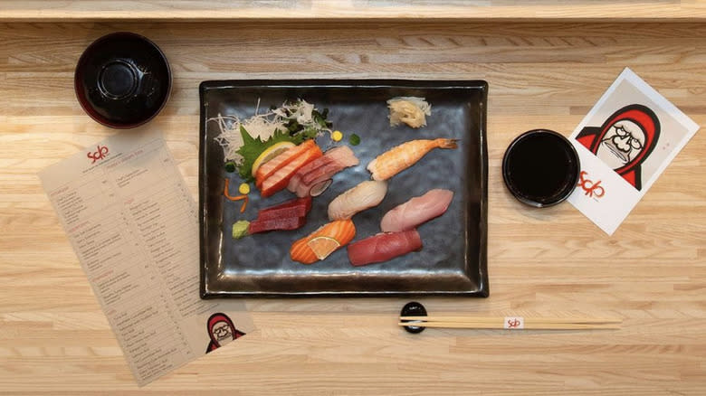 plate of sushi and menu at Soko