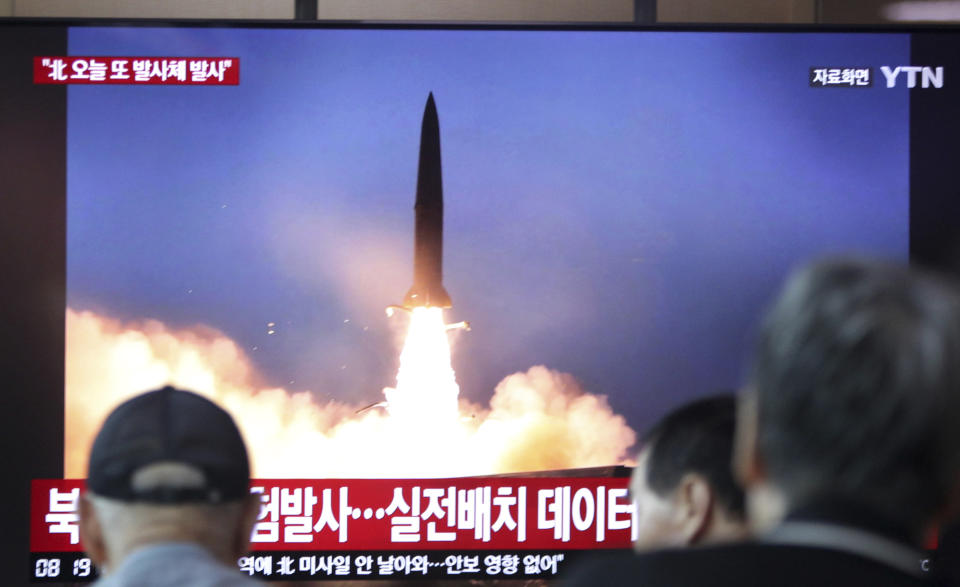 People watch a TV showing a file footage of a North Korea's missile launch during a news program at the Seoul Railway Station in Seoul, South Korea, Friday, Aug. 2, 2019. South Korea's military said North Korea fired unidentified projectiles twice Friday into the sea off its eastern coast in its third weapons tests in just over a week. The sign reads "North Korea fired unidentified projectiles." (AP Photo/Ahn Young-joon)