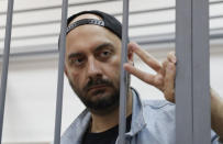 Russian theatre director Kirill Serebrennikov, who was detained and accused of embezzling state funds, gestures inside the defendants' cage as he attends a hearing on his detention at a court in Moscow, Russia August 23, 2017. REUTERS/Tatyana Makeyeva