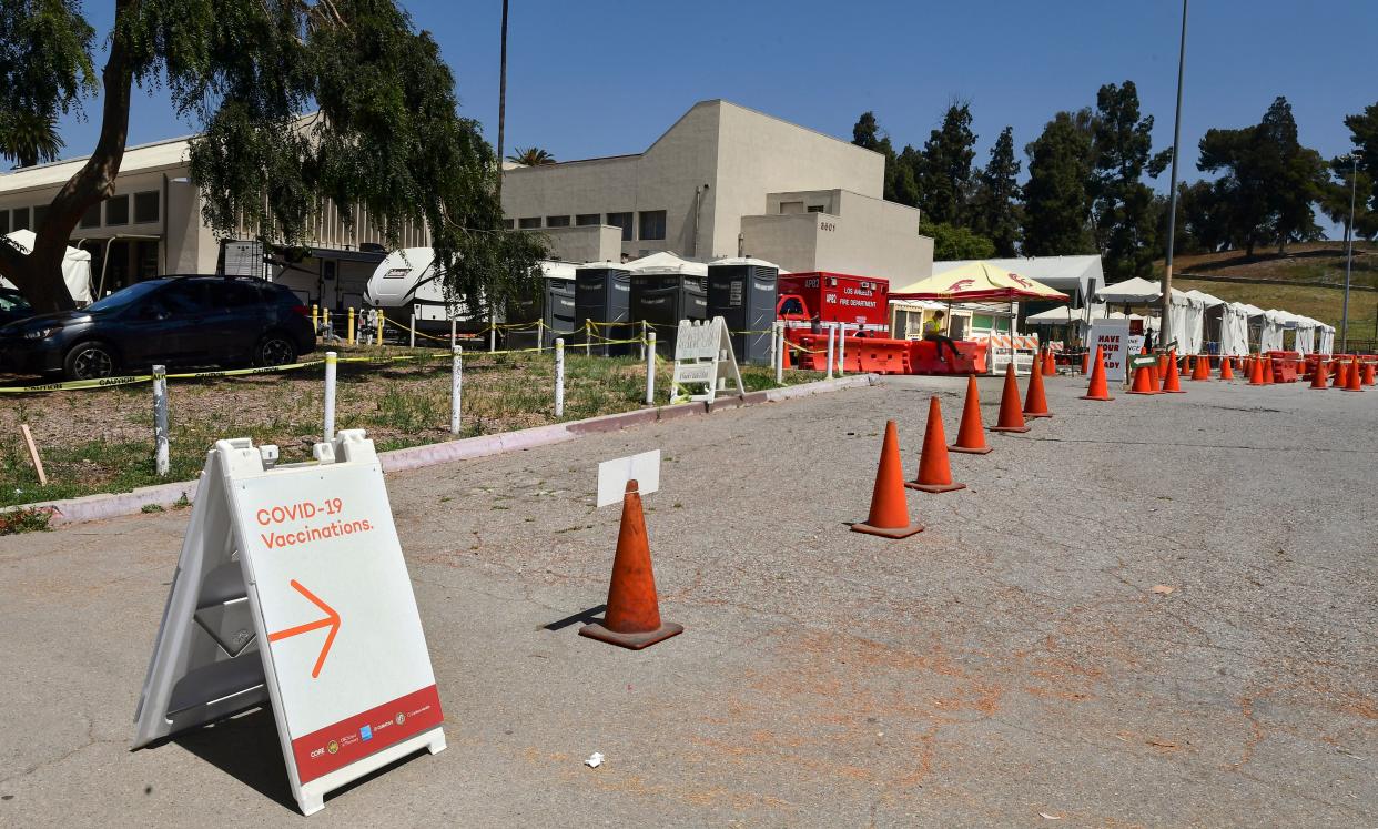 A Covid-19 vaccine site worker sits alone waiting for people at the Lincoln Park Covid-19 vaccine facility in Los Angeles, California on May 3, 2021. (Frederic J. Brown/AFP via Getty Images)