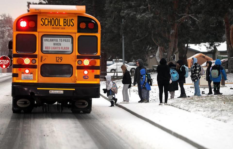 Kennewick elementary students board their school bus on West Metaline Avenue in Kennewick. The overnight snowfall, that measured less than an inch in most places, did not cause many delays or school closures in the Tri-Cities. But many outlying and rural schools were on a two hour delay.