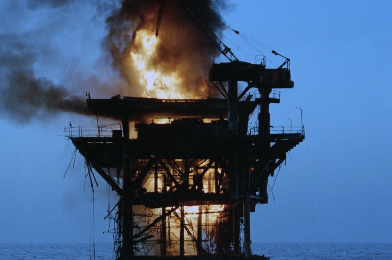 An Iranian command and control platform is set afire October 19, 1987, after being shelled by four U.S. Navy destroyers. The shelling was a response to a recent Iranian missile attack on a reflagged Kuwaiti super tanker. File Photo courtesy of U.S. Navy