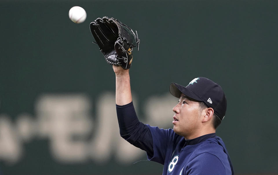 Seattle Mariners pitcher Yusei Kikuchi catches a ball during his team's practice at Tokyo Dome in Tokyo, Saturday, March 16, 2019. Just as he was adjusting to life in the United States, Kikuchi is back in Japan getting ready to make his Major League pitching debut in front of a sellout crowd at Tokyo Dome. Kikuchi will be on the mound in Game 2 of the MarinersÅf season-opening series in Japan. (AP Photo/Eugene Hoshiko)