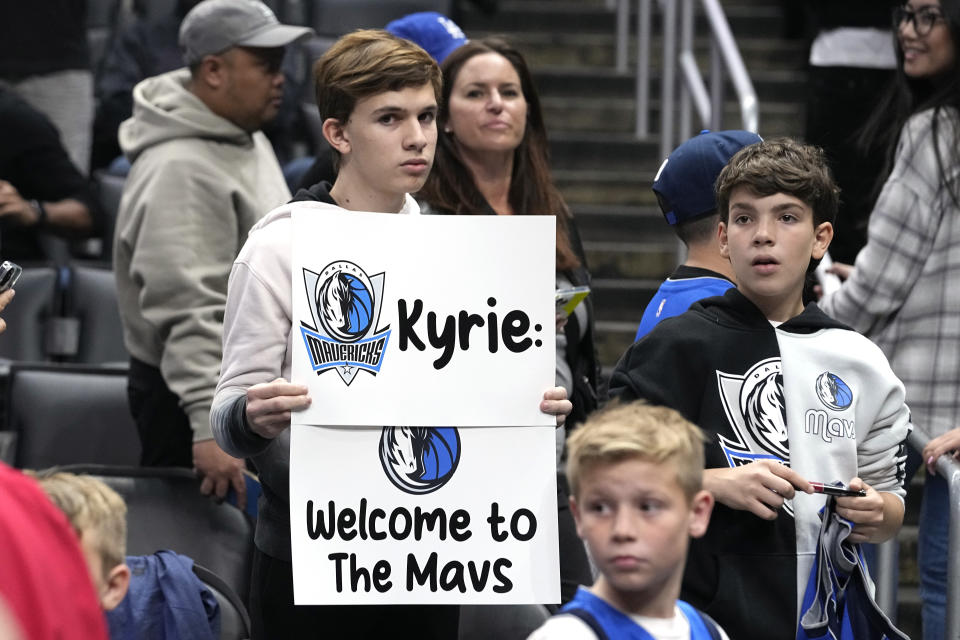 A young fans holds up a sign for Dallas Mavericks guard Kyrie Irving prior to an NBA basketball game against the Los Angeles Clippers Wednesday, Feb. 8, 2023, in Los Angeles. (AP Photo/Mark J. Terrill)