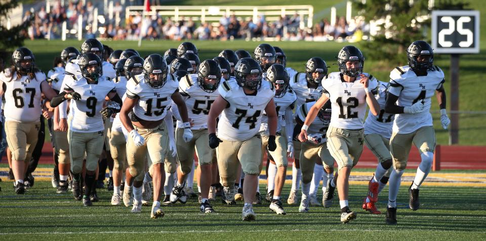 Rush-Henrietta race onto the field to face Victor during their Section V season opener.