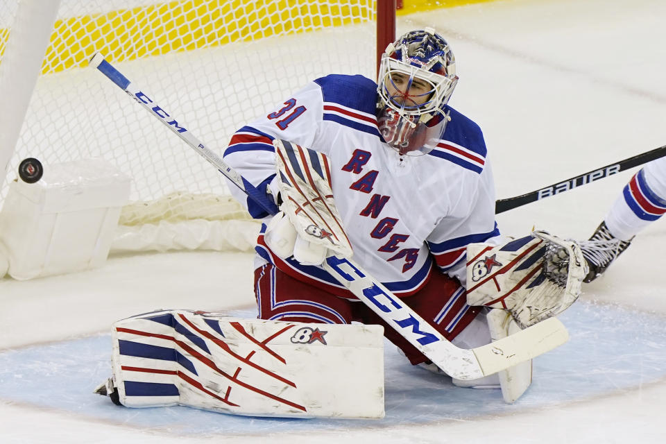 A goal scored by New Jersey Devils center Jack Hughes (86) goes into the net behind New York Rangers goaltender Igor Shesterkin (31) during the first period of an NHL hockey game between the New Jersey Devils and the New York Rangers, Thursday, March 4, 2021, in Newark, N.J. (AP Photo/Kathy Willens)