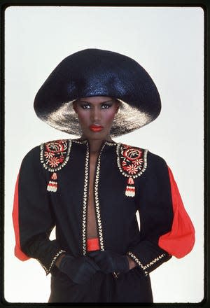 Portrait of Jamaican-born model, singer, and actress Grace Jones as she wears a black hat and multi-colored top