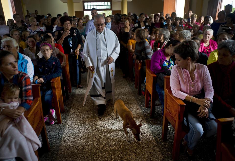 Father Cirilo Castro takes part in the consecration Mass of the Sagrado Corazon de Jesus, or Sacred Heart, Catholic church, in Sandino, Cuba, Saturday, Jan. 26, 2019. The parish is one of three Catholic churches that the Cuban government authorized to be built and the first of the three to be completely finished, with the help of Tampa's St. Lawrence Catholic Church in Florida. (AP Photo/Ramon Espinosa)