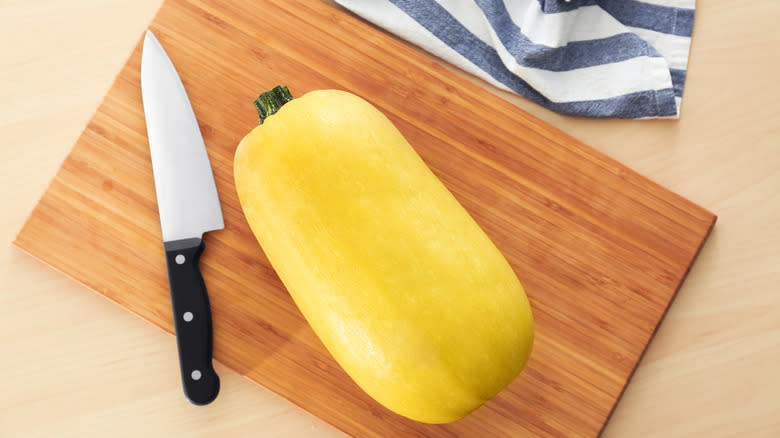 Knife and squash on cutting board
