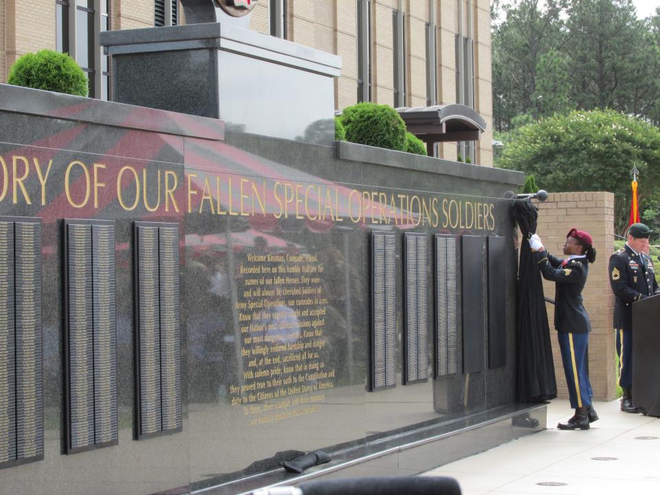 The U.S. Army Special Operations Command unveils its memorial wall with the name of the command's latest soldier to die in Afghanistan, Staff. Sgt. Ryan Knauss, during a ceremony Thursday, May 26, 2022, in the USASOC Memorial Plaza at Fort Bragg.