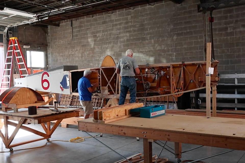 Workers make repairs to a 1918 Haviland DH-4 in downtown Wichita that is being restored to look like the plane that Erwin Bleckley and Harold Goettler flew to their deaths in an attempt to to locate the famed Lost Battalion on October 6, 1918. The plane, made in Dayton, Ohio, was restored once before but crashed on its maiden flight in 2020. The Bleckley Foundation in Wichita then took possession of the wreckage and hopes to restore it to flying condition and use it to educate people about Wichita Medal of Honor recipient Erwin Bleckley.