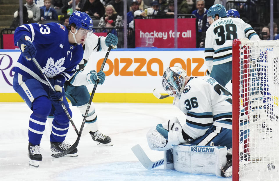 Toronto Maple Leafs forward Matthew Knies (23) watches the puck go in the net as San Jose Sharks goaltender Kaapo Kahkonen (36) is scored on during the second period of an NHL hockey game, Tuesday, Jan. 9, 2024 in Toronto. (Nathan Denette/The Canadian Press via AP)