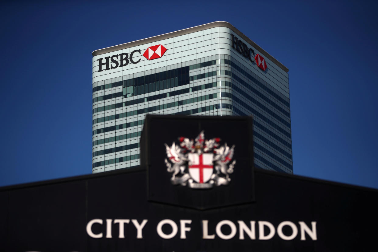 HSBC’s building in Canary Wharf is seen behind a City of London sign outside Billingsgate Market in London. Photo: Hannah McKay/Reuters