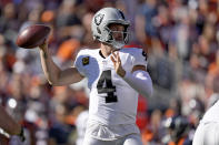 Las Vegas Raiders quarterback Derek Carr (4) throws against the Denver Broncos during the first half of an NFL football game, Sunday, Oct. 17, 2021, in Denver. (AP Photo/David Zalubowski)