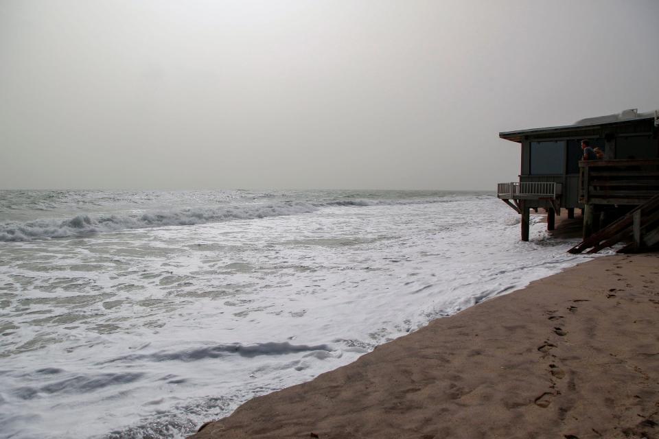 Sections of the beach at Sexton Plaza is seen at high tide, Tuesday, Oct. 3, 2023, during hazy conditions from a wildfire in Quebec, Canada, which made its way down to east central Florida, according to the National Weather Service in Melbourne. Some areas across Florida, especially the Treasure Coast and Orlando areas, may exhibit poor air quality to anyone sensitive to particle pollution. “It's going to start improving later (Tuesday),” said Melissa Watson, a meteorologist with the National Weather Service. “We can’t say it will be perfectly clear, but it will definitely be less hazy.”