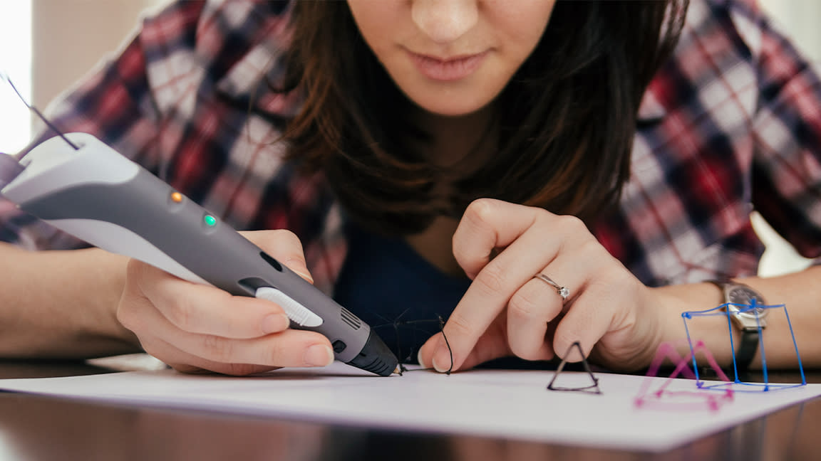  The best 3D pens; as represented by a person using a 3D pen  