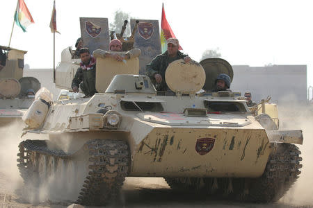 A tank of Peshmerga forces drives towards the town of Bashiqa, east of Mosul, during an operation to attack Islamic State militants in Mosul, Iraq, November 7, 2016. REUTERS/Azad Lashkari