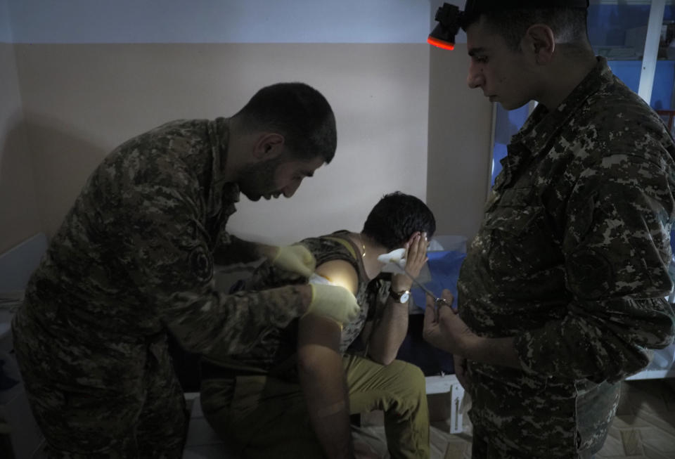 An Armenian wounded soldier receives treatment in a military hospital near the frontline in the separatist region of Nagorno-Karabakh, Sunday, Oct. 25, 2020. Armenia and Azerbaijan have accused each other of violating the new U.S.-brokered cease-fire aimed to halt the fighting over the separatist region of Nagorno-Karabakh. (AP Photo)