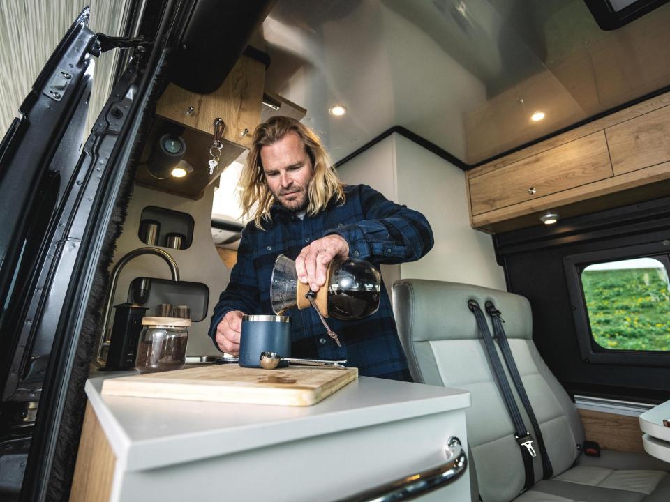 A person at the kitchen inside Airstream's new Rangeline Touring Coach