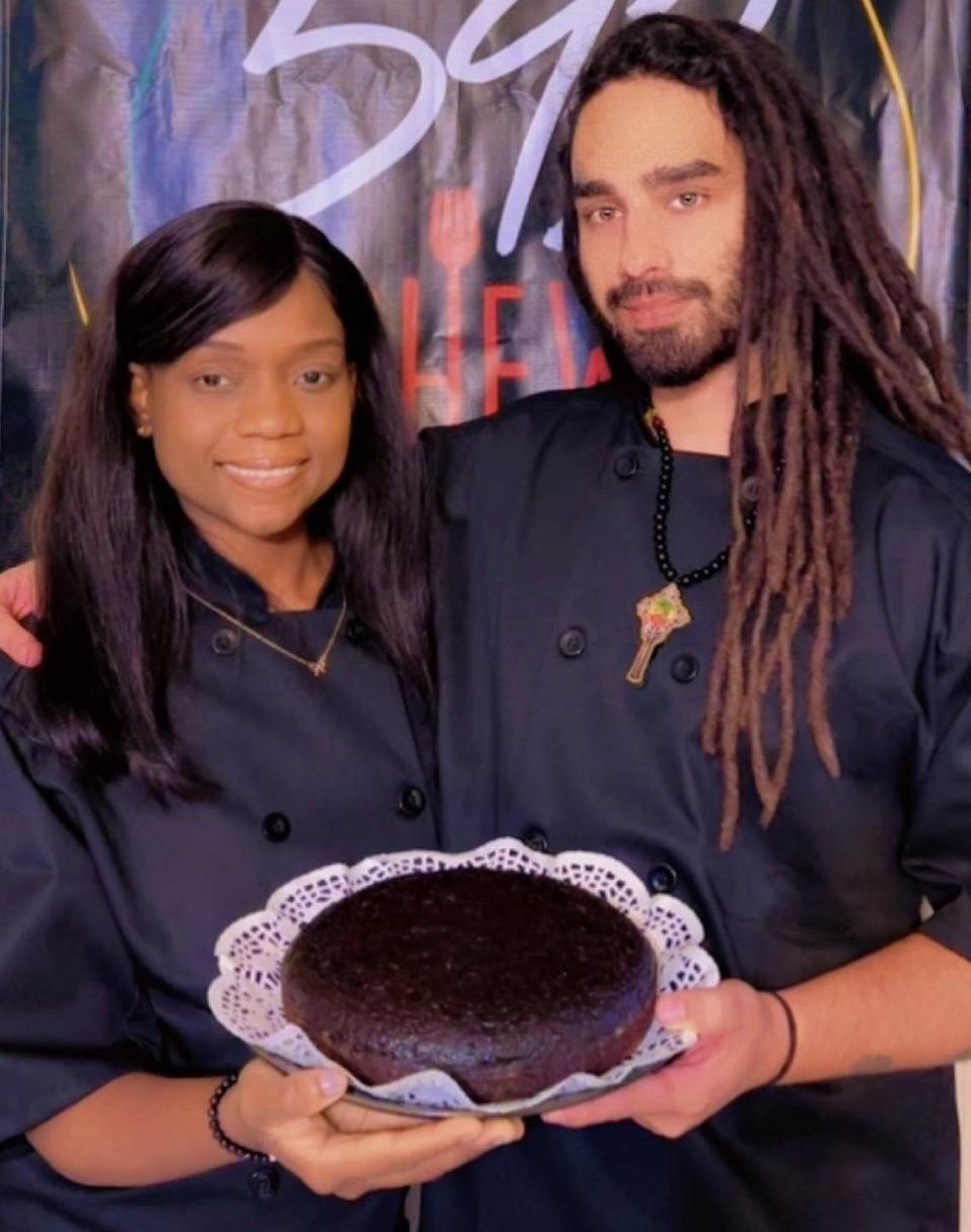 Kyle De’Armond and his wife and business partner Whitney De’Armond with one of 592 Chew’s black cakes. Both grew up in Guyana.