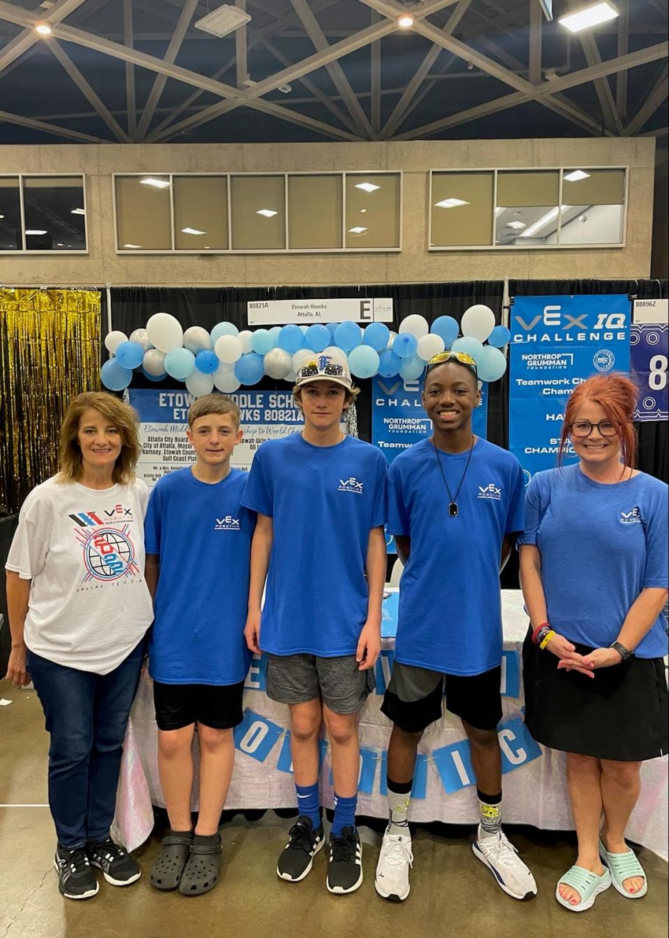 Members of the Etowah Middle School robotics club alongside instructor Tammy Basaraba and Duck Springs Elementary School robotics sponsor Genia Craft.