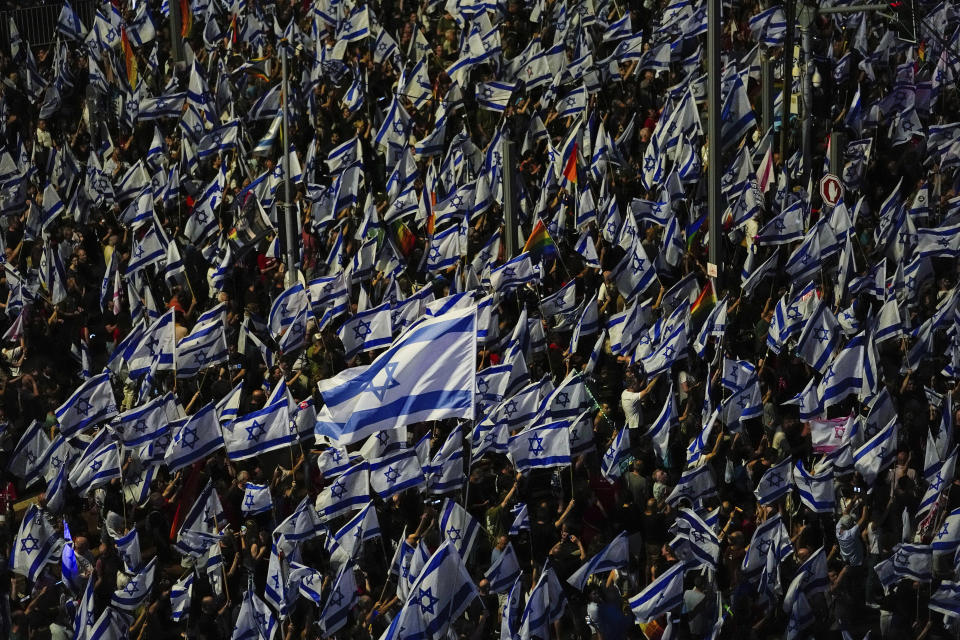 Israelis wave their national flag during a protest against plans by Prime Minister Benjamin Netanyahu's government to overhaul the judicial system in Tel Aviv, Saturday, June 3, 2023. (AP Photo/Ariel Schalit)