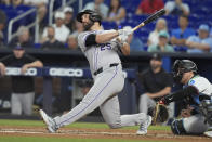 Colorado Rockies' Jacob Stallings (25) hits a three-run home run during the second inning of a baseball game against the Miami Marlins, Thursday, May 2, 2024, in Miami. (AP Photo/Marta Lavandier)