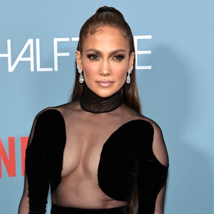 jennifer lopez wearing black cut out dress on halftime red carpet