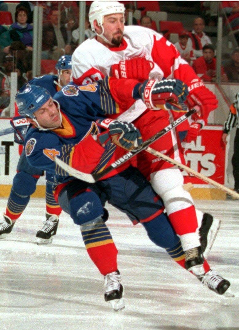 Detroit Red Wings' Martin Lapointe checks St. Louis Blues' Marc Bergevin during the second period in Game 5 of the first round playoff series at Joe Louis Arena, April 25, 1997.