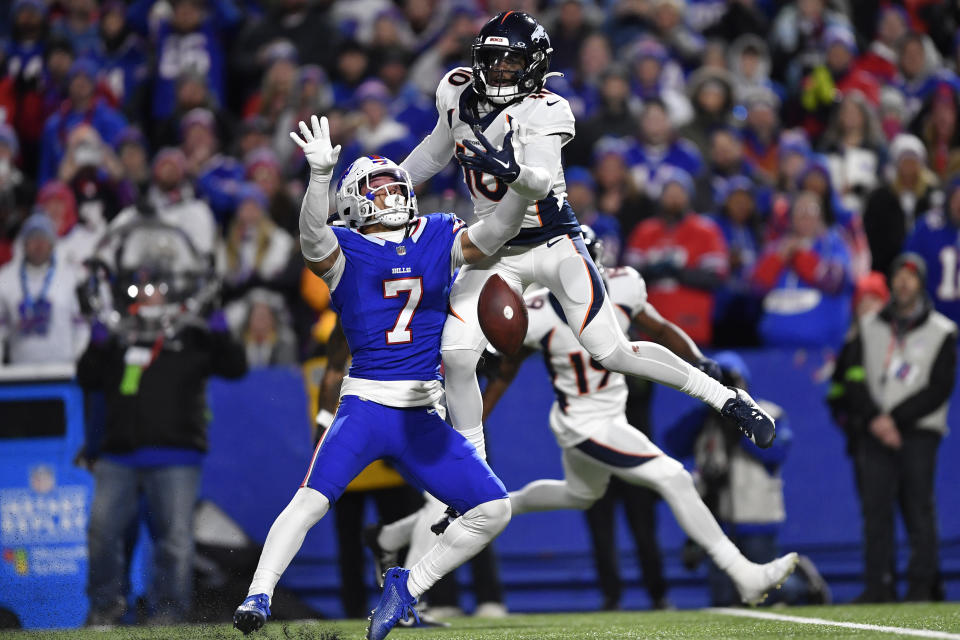 Buffalo Bills' Taron Johnson (7), left, breaks up a pass intended for Denver Broncos' Jerry Jeudy, top, during the second half of an NFL football game, Monday, Nov. 13, 2023, in Orchard Park, N.Y. Johnson was called for pass interference on the play, allowing the Broncos to move into field goal range and win the game. (AP Photo/Adrian Kraus)