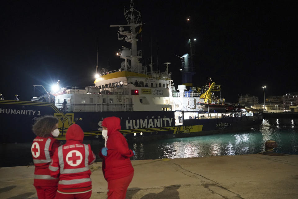 The SOS Humanity 1 humanitarian ship is moored in the Italian southern port town of Crotone, Monday, March 4, 2023. German charity SOS Humanity said the Libyan coast guard used violence and fired live bullets as its crew rescued migrants in the Mediterranean Sea on Saturday. The charity said that several migrants aboard three unseaworthy boats had to jump into the water. It said that it rescued 77 people, but that others were forced aboard a coast guard vessel. Some family members were separated and at least one migrant drowned. (Antonino D'Urso/LaPresse via AP )