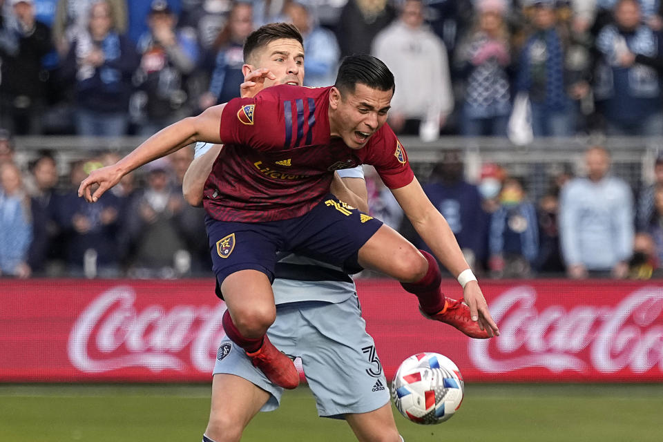 Sporting Kansas City defender Andreu Fontas (3) and Real Salt Lake forward Rubio Rubin, front, battle for the ball during the first half of an MLS soccer match Sunday, Nov. 28, 2021, in Kansas City, Kan. (AP Photo/Charlie Riedel)