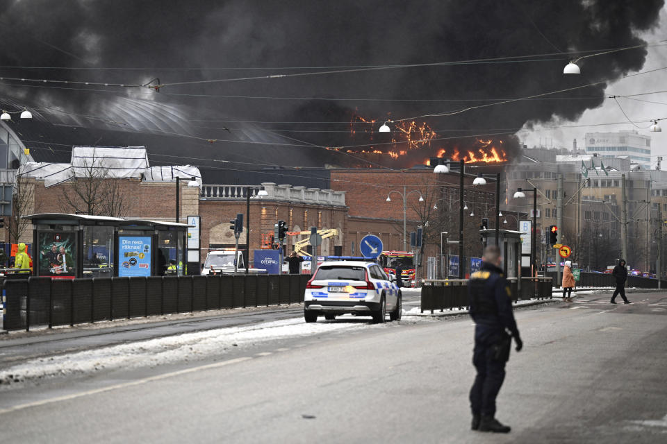 Smoke rises after a fire broke out at the Liseberg amusement park's new water world Oceana in Goteborg, Sweden, Monday Feb. 12, 2024. A fire raged through a water park attraction with several slides in the Nordic region’s largest fun fair with a huge plume of black smoke drifting over Goteborg, Sweden’s second largest city. Authorities, including the police and fire fighters, could not say whether there were any casualties. (Björn Larsson Rosvall/TT News Agency via AP)