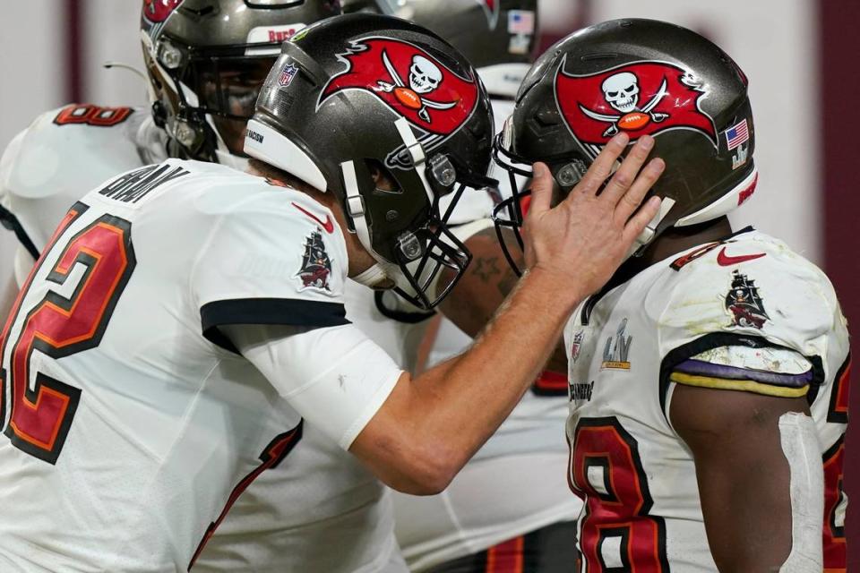 Tampa Bay Buccaneers running back Leonard Fournette, right, celebrates with teammate Tom Brady after scoring on a 27-yard touchdown run during the second half of the NFL Super Bowl 55 football game against the Kansas City Chiefs Sunday, Feb. 7, 2021, in Tampa, Fla. (AP Photo/Lynne Sladky)