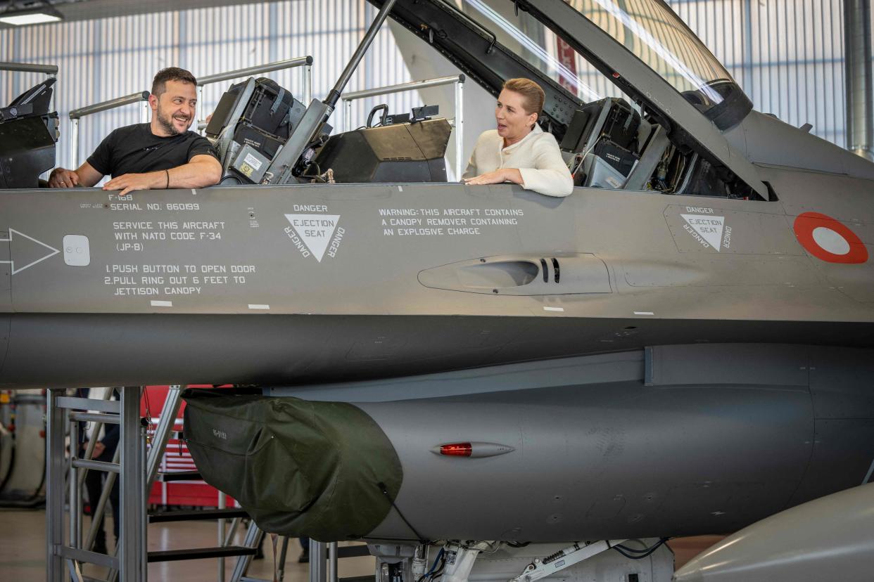 Zelensky (L) and Danish PM Mette Frederiksen sit in an F-16 fighter jet in the hangar of the Skrydstrup Airbase in Vojens, northern Denmark (Ritzau Scanpix/AFP via Getty)