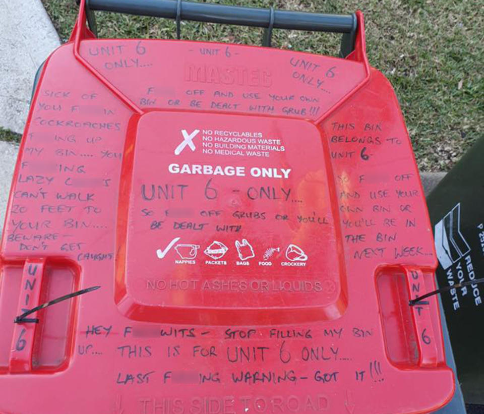 A photo of the Sydney bin lid is covered in expletives and threats, including 'use your own bin or you'll be in the bin next week'.