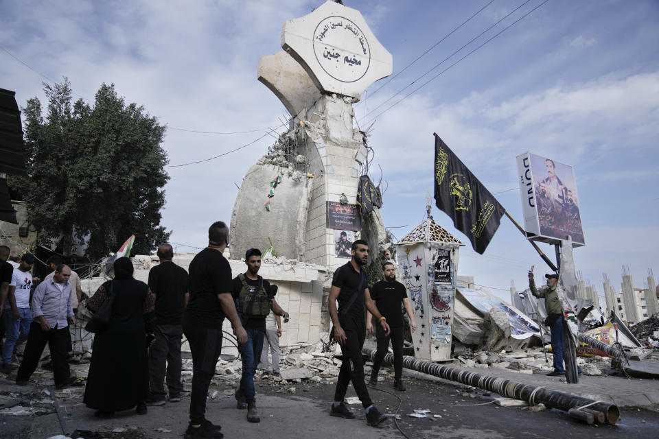 Palestinians stand by a shop destroyed in an Israeli raid in Jen refugee camp in the West Bank on Monday, Oct. 30, 2023. (AP Photo/Majdi Mohammed)