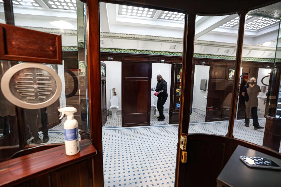 Employees clean the public toilets of the Lavatory de La Madeleine