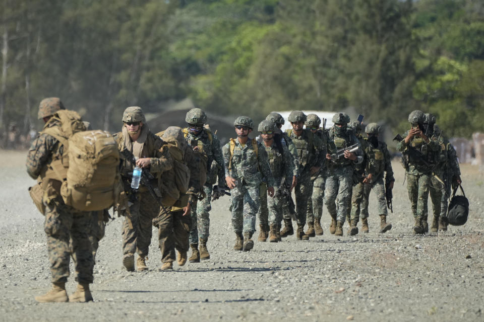 U.S. and Philippine troopers prepare to board U.S. Army CH-47s at Paredes Air Station at Pasuquin, Ilocos Norte province during a joint military exercise in northern Philippines on Monday, May 6, 2024. American and Filipino marines held annual combat-readiness exercises called Balikatan, Tagalog for shoulder-to-shoulder, in a show of allied military readiness in the Philippines' northernmost town facing southern Taiwan. (AP Photo/Aaron Favila)