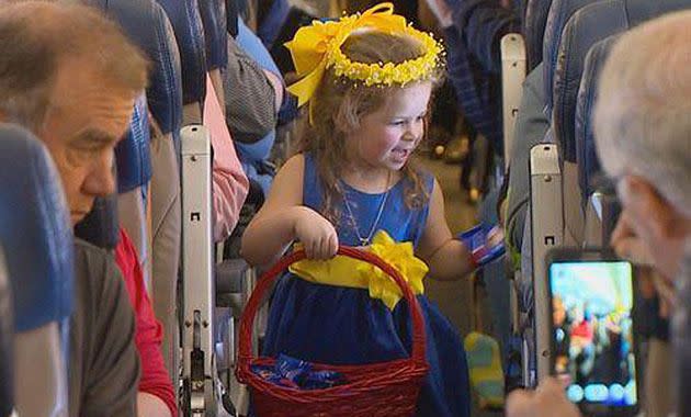 A flower girl hands out peanuts. Photo: Josh Stephen/WFAA