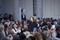 Model Kaia Gerber wears a creation as part of Max Mara's Fall/Winter 2020/2021 collection, presented in Milan, Italy, Thursday, Feb. 20, 2020. Sitting at left is Anna Wintour. (AP Photo/Antonio Calanni)