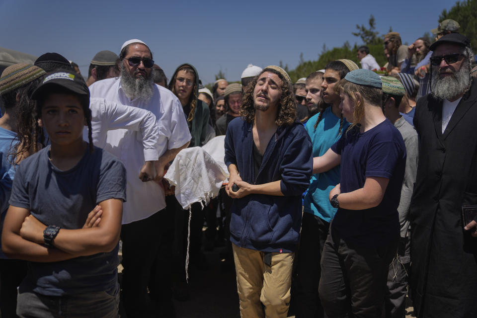 Mourners carry the body of Nachman Mordoff, 17, during his funeral in the West Bank Israeli settlement of Shilo, Wednesday, June 21, 2023. Mordoff was among four Israelis killed by two Palestinian attackers that opened fire at a restaurant and gas station near the Israeli settlement of Eli in the West Bank on Tuesday. The attackers were killed by Israeli fire as violence continued to roil the West Bank. (AP Photo/Ohad Zwigenberg)