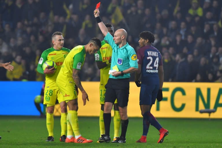 Referee Tony Chapron showing a red card to Nantes' Diego Carlos after tackling the player, for which he has been banned for six months